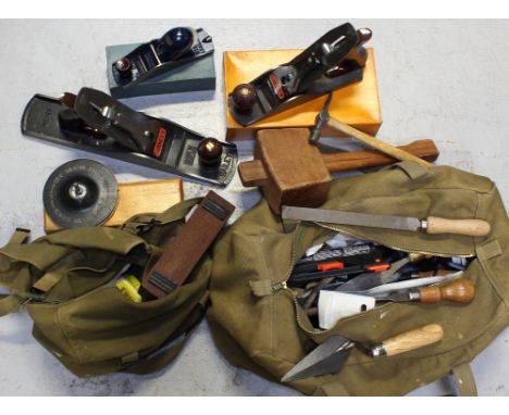 Two vintage canvas haversacks containing a quantity of tools to include hammers, screwdrivers, wooden-handled chisels, two St