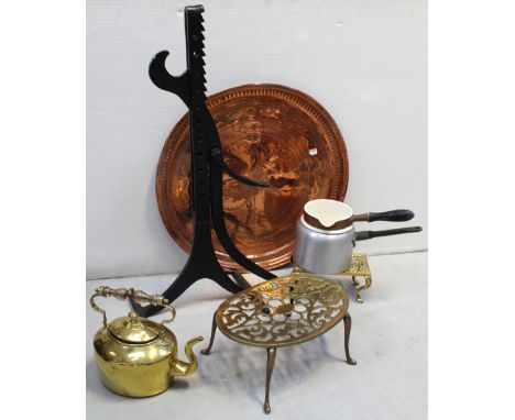 A wrought iron carriage jack, an Eastern copper circular tray, diameter 58cm, three vintage brass trivets and a vintage brass