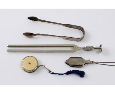 A small mixed lot of silver and metalware to include hallmarked silver sugar tongs, a tuning fork, a pair of mid century lorg