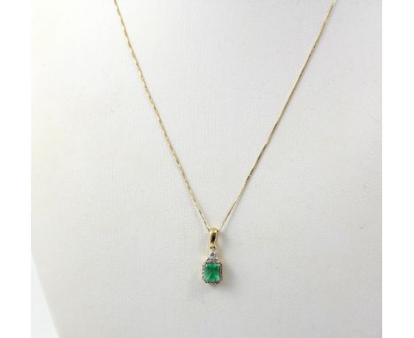 An 18ct gold chain and pendant with emerald-set green stone and white stone surround, approx 2.9g.