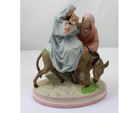 Robinson &amp; Leadbetter 1865-1924: a religious figurine group of Mary, Joseph and the infant Jesus riding a donkey, on a st