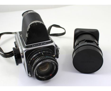 A Hasselblad 500 66 single lens reflex camera with 80mm lens, and an Karl Zeiss Distagon 4/50 50mm lens with lens hood (2).