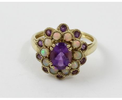 A 9ct gold ladies' dress ring, floral-set with central oval amethyst-coloured stone, opals and amethyst-coloured stone surrou