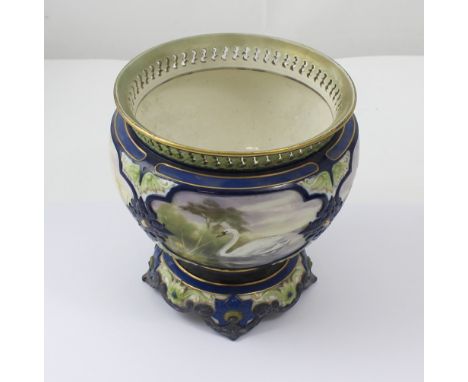 A Hadley's Worcester jardinière with pierced rim and acanthus moulded decoration, reserves painted with swans in naturalistic