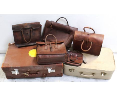 A collection of leather satchels, holdalls and two vintage suitcases, width of largest 65.5cm (7).
