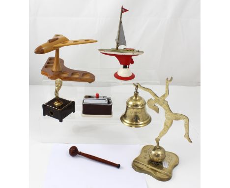 A Barclay table lighter, an Art Deco style table lighter in the form of a boat, a pipe stand in the form of an aeroplane, and