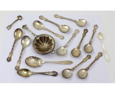 A set of ten Victorian silver teaspoons with shell and floral decoration, marked Sterling 1895, a silver Art Nouveau tea stra