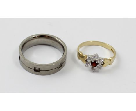 A small 9ct garnet and past daisy cluster ring, size L1/2, a titanium and chip diamond wedding band, size P1/2, a silver gilt