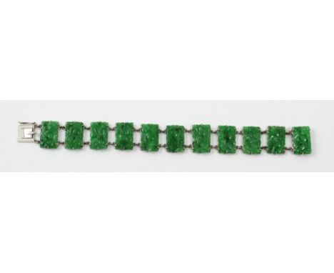 A 9ct white gold mounted jade panel bracelet, each panel carved with fruit, length 18.5cm, approx 19g. CONDITION REPORT No ob