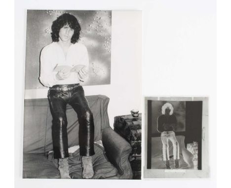 Jim Morrison, a black and white photograph of The Doors front man seated upon the back of a sofa with open book in hands, 25 