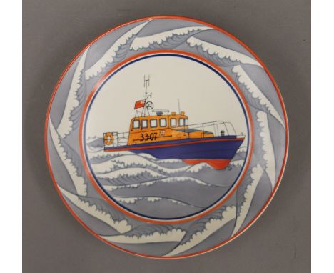 A Poole Pottery dish decorated with a lifeboat in an associated Poole Pottery box. 26.5 cm diameter.