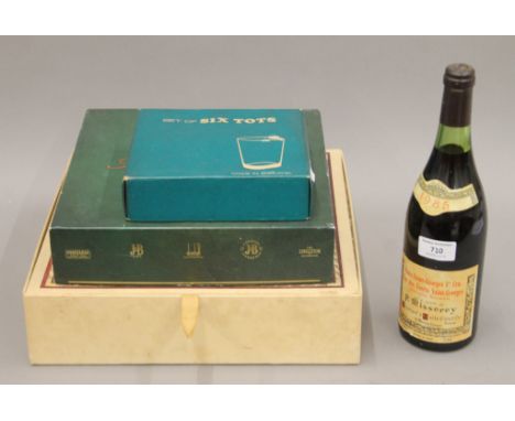 A bottle of 1985 Nuits-Saint-Georges premier cru, a boxed set of Cinzano, a boxed games compendium including five Scotch Whis