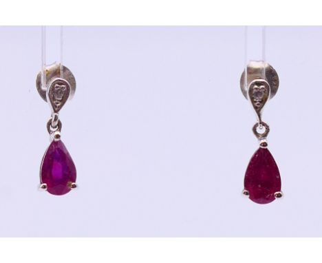 A pair of contemporary ruby and silver earrings with butterfly clips, stamped 925.  1.5 cm high. 