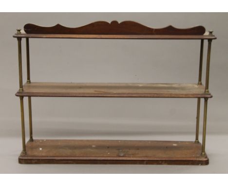 A 19th century brass and mahogany wall shelf. 84 cm wide.