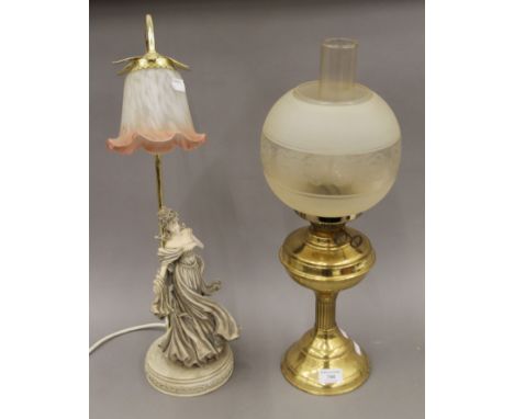 A brass oil lamp and a lamp formed as a lady. The former 54 cm high.
