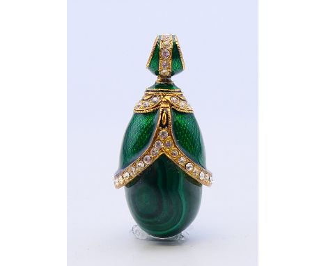 A malachite and enamel egg form pendant.  3.5 cm high.