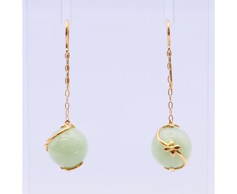 A pair of gold and jade ball earrings.  3.5 cm high. 