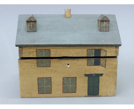 A tea caddy in the form of a house. 26 cm wide.