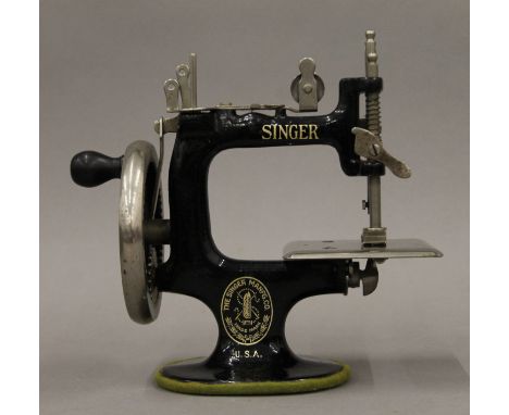 An antique Singer miniature (child's) sewing machine "A Singer for the Girls" circa 1910, complete with original box and clam