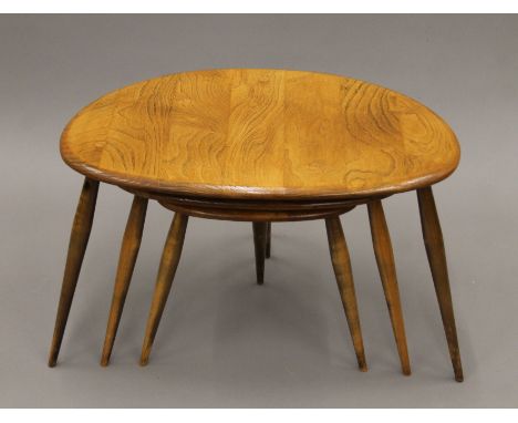 A nest of three Ercol pebble coffee tables. 46 cm wide.