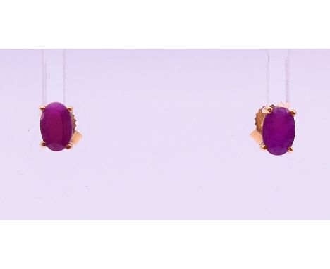 A pair of 9 ct gold ruby earrings.  5 cm high.