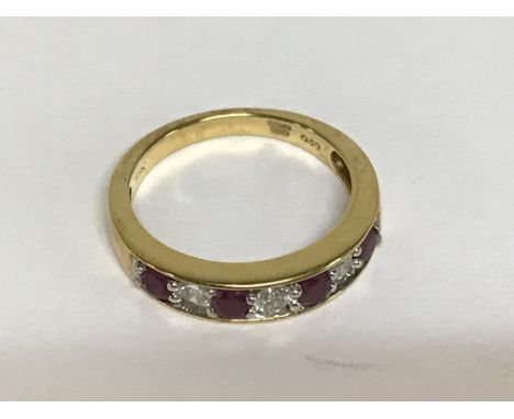 A 18 k gold ring inset with diamonds and rubies.size k .