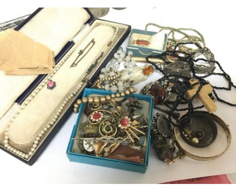 A collection of costume jewellery a bangle with gold key attached amber brooch and other oddments (a lot)