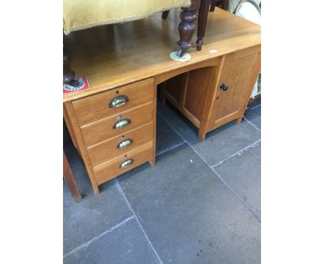 A light wood pedestal desk. 