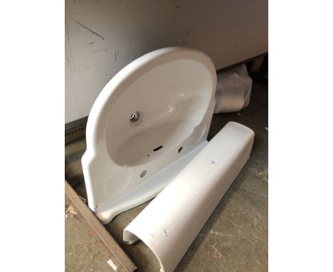 A ceramic pedestal bathroom sink 