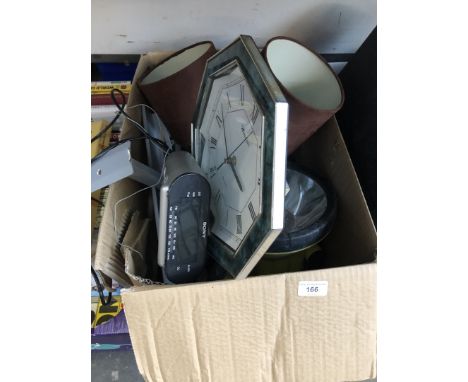 A box of misc icluding a clock, table lamp, large torch and an alarm clock radio 