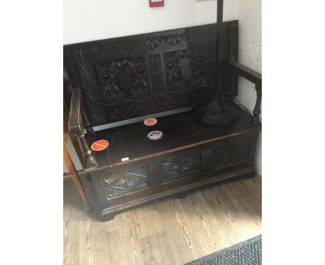 A carved oak monk's bench. 