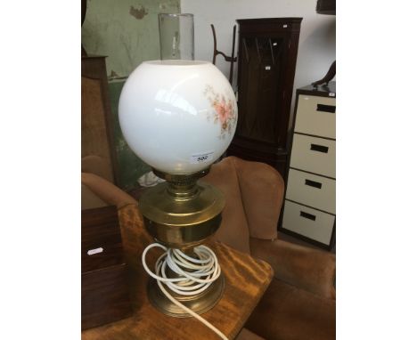 A brass lamp with glass shade. 