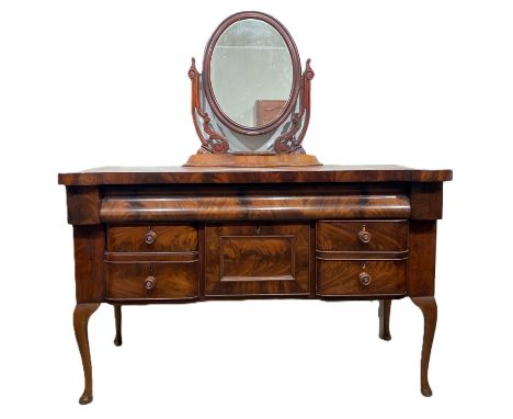 A mid Victorian mahogany dressing table, with ogee moulded long drawer over a niche and further drawers

With a little adapta