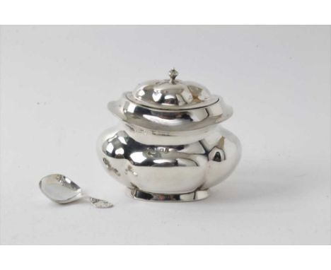 Edwardian silver tea caddy of lobed form with hinged cover, (Birmingham 1905), 9.5cm high and silver caddy spoon (2)