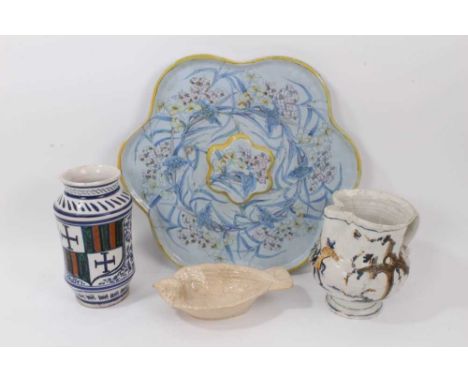 A group of continental ceramics, including a large polychrome faience dish of flower form, a faience jug, an albarello and a 