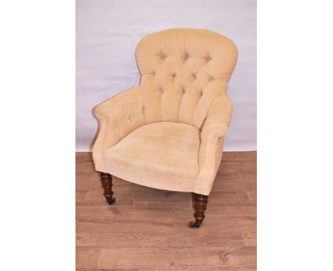 Early Victorian mahogany button upholstered armchair, raised on turned mahogany legs, with brass cappings and castors