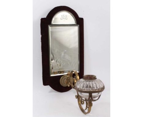 Aesthetic style mirrored wall oil lamp, with wall bracket with engraved mirrored panel above ornate scrolling arm, holding oi