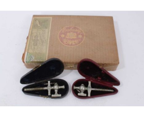 Two early 20th century champagne taps, each cased, together an unopened box of vintage Embassy Emperor cigars. (3)