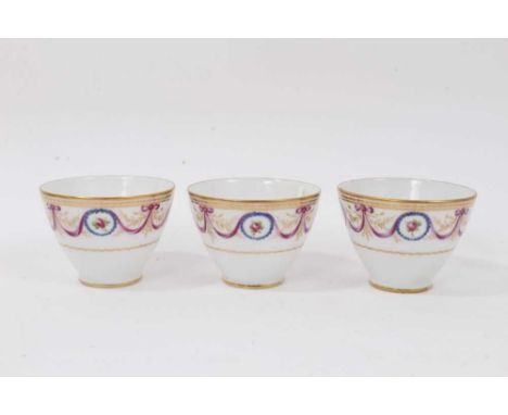 Three early 19th century Paris porcelain tea bowls, decorated in enamels and gilt with floral swags