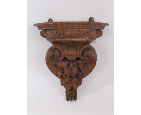 19th century carved pine bracket, trapezoidal form, carved with fruit, 29cm wide