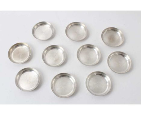 Ten Continental Art Deco engine turned dishes, 7.2cm diameter, 15ozs