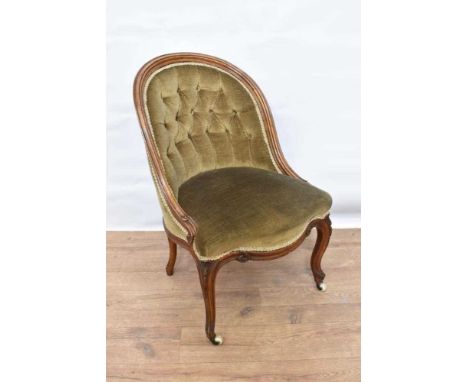 Early Victorian button upholstered tub chair, with carved showwood frame on cabriole legs and castorsProvenance: Removed from