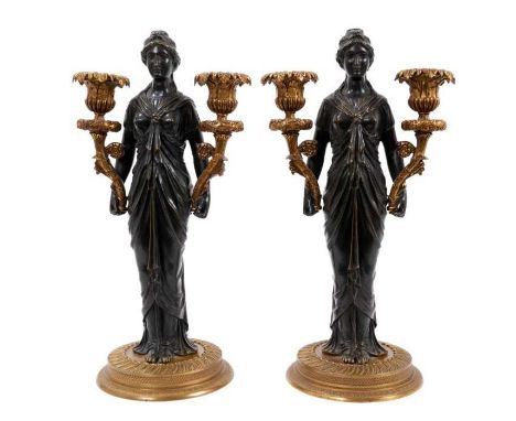 Pair of early 19th century French bronze and ormolu candlesticks, each modelled as a classical maiden holding twin cornucopia