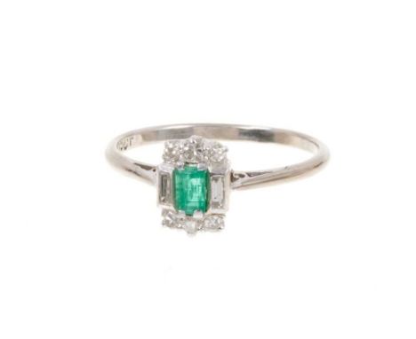 Art Deco emerald and diamond ring with a rectangular step cut emerald measuring 3.7mm x 2.5mm flanked by six single cut diamo