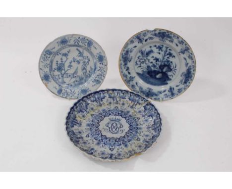 Three 18th century delftware plates, including one English and painted with a Chinese figure in a garden, one Dutch with cent