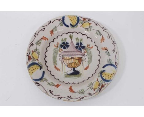 An 18th century polychrome delftware plate, the centre decorated with an urn, 22.5cm diameter