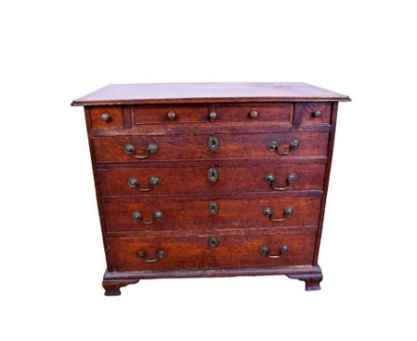 Mid 18th century oak chest of small size, fitted with slide and four short drawers over four long graduated drawers on ogee b