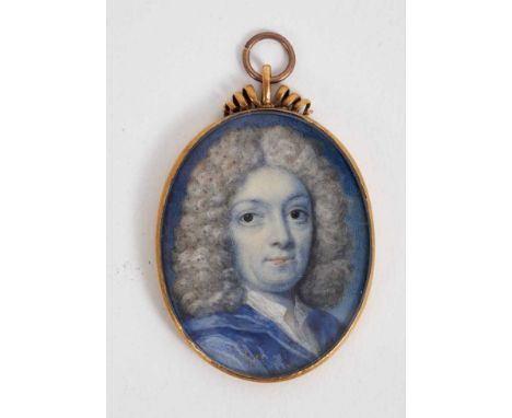 English School, early 18th century, watercolour miniature portrait on ivory, a gentleman with powdered wig and blue jacket, e