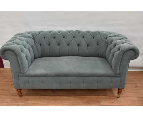 Victorian teal coloured button upholstered chesterfield sofa, raised on turned legs and castors, approximately 175cm long