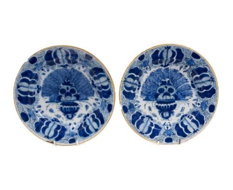 Pair of 18th century Dutch blue and white peacock pattern delftware dishes, yellow-painted rims, marks to backs, 27cm diamete